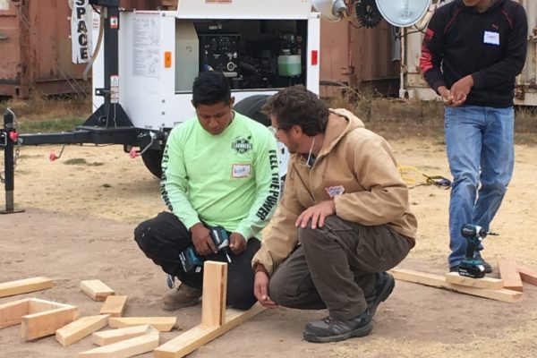 Latino construction workers kneeling on the ground