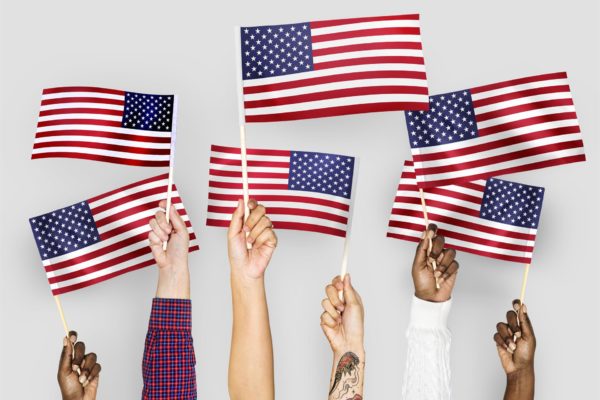 Hands holding the American flag in the air