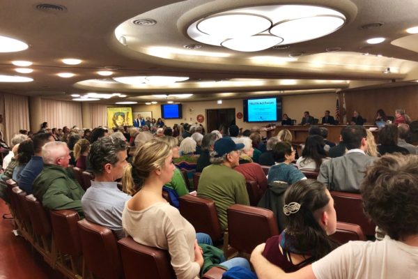 Attendees sitting in chairs at Truth Act Forum