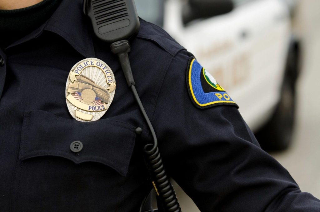 Close-up of police officer's chest with badge