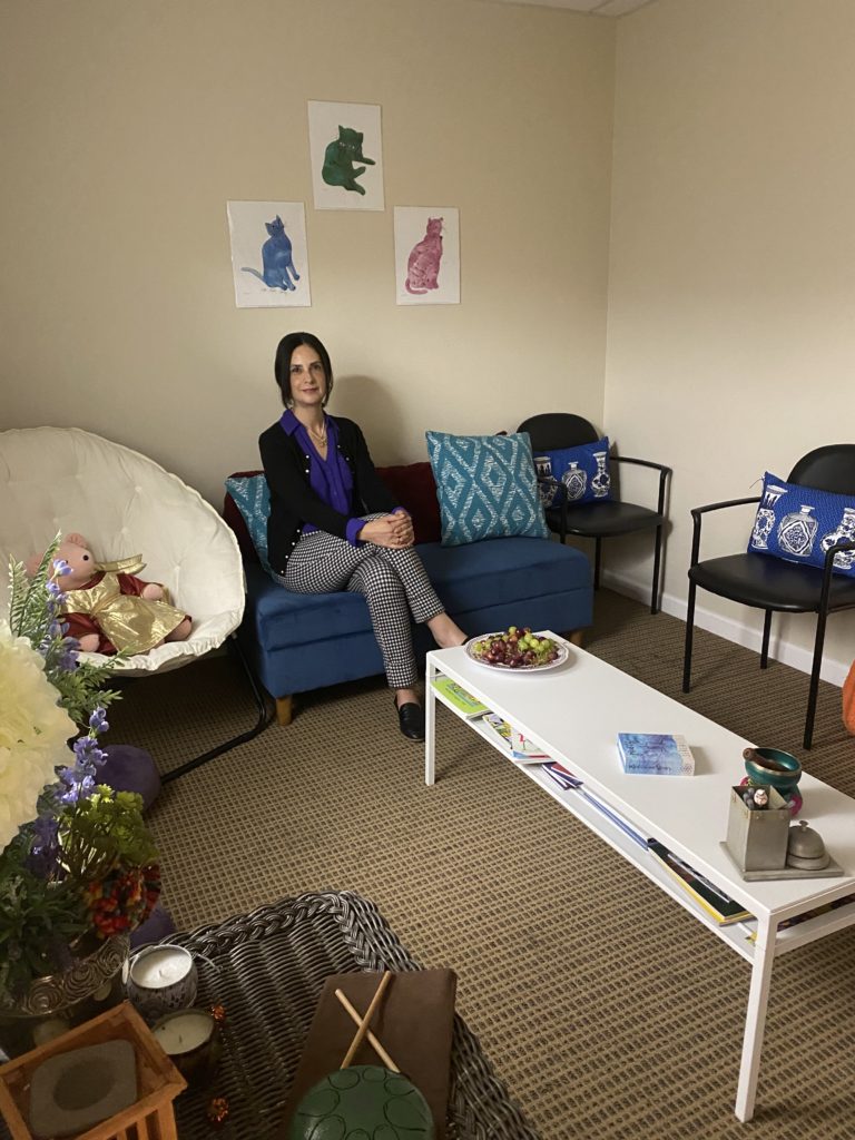 Dr. Anabel Plasencia sits in her office space where she hosts individual therapy and psychoeducational groups. 