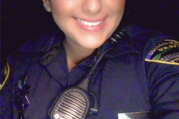 Officer Jessica Trujillo of the San Rafael Police Department smiles for a selfie in uniform