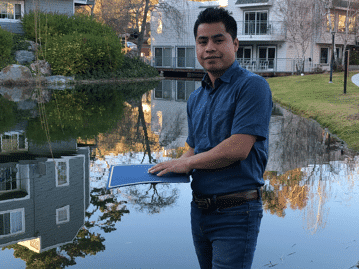 Timoteo Vasquez-Mendez standing next to a creek. 