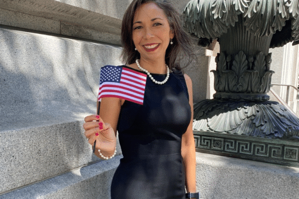 Kristy Ponce, Canal Alliance staff member, waves an U.S. flag