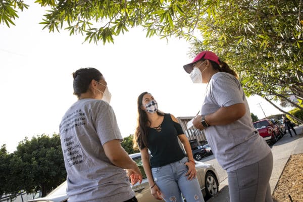 Canal Alliance staff and community member talking in the neighborhood.