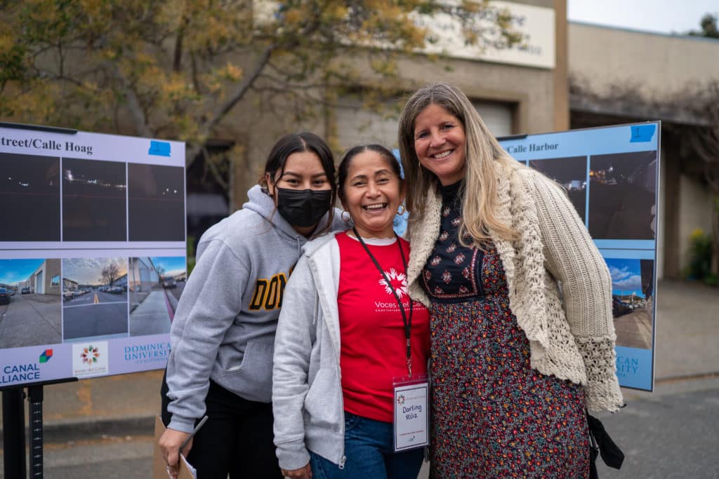 Darling Ruiz poses with community members at the Voces Del Canal community event. 